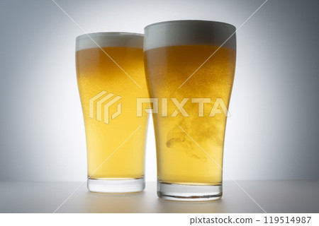 Cold delicious beer poured into a glass Cold delicious beer poured into a glass 119514987