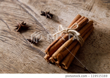 cinnamon sticks on wooden background 119515169