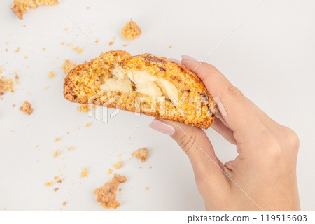 Cookies in hand. homemade oatmeal cookies filled with cheese on a light background, top view 119515603