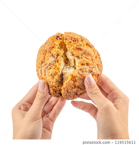 Female hand holding sweet oat cookies with cheese filling isolated on white background 119515611