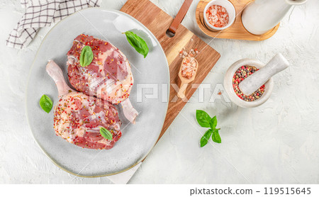 Raw duck leg meat. marinated meat is ready for baking on a light background, top view. copy space 119515645