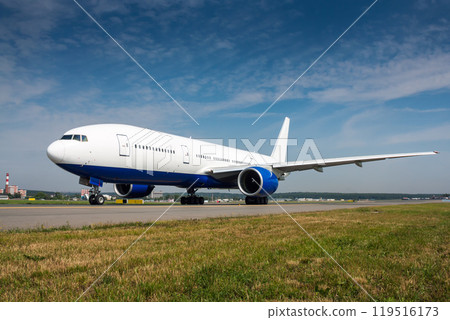 Wide body passenger airplane taxiing on the main taxiway Wide body passenger airplane taxiing on the main taxiway 119516173
