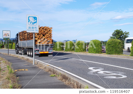 A trailer truck loaded with timber drives along Melody Road near Yonago Kitaro Airport in Sakaiminato, Tottori Prefecture. 119516407