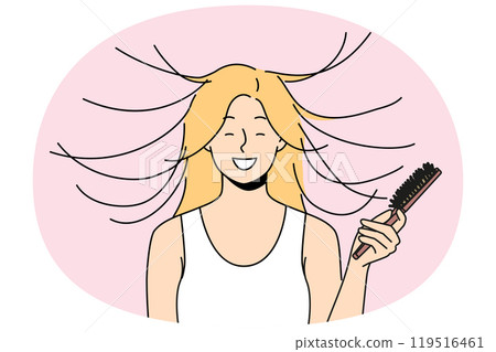 Woman combs hair and smiles, seeing effect of static magnetization of hairstyle. 119516461