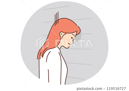 Upset woman banging her head against wall 119516727