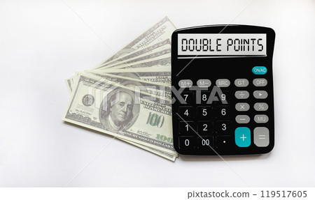 The text on the calculator display with double points on a white background with dollars The text on the calculator display with double points on a white background with dollars 119517605