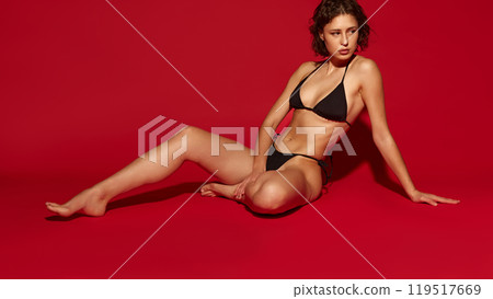 Sitting in casual pose, young woman gazes thoughtfully away, showcasing her natural, healthy appearance and confidence. Sitting in casual pose, young woman gazes thoughtfully away, showcasing her natural, healthy appearance and confidence. 119517669