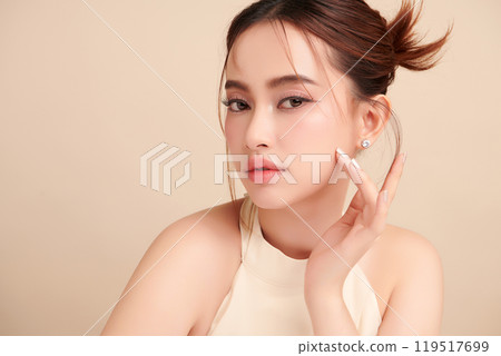Beautiful young asian woman with clean fresh skin on beige background, Face care, Facial treatment, Cosmetology, beauty and spa, Asian women portrait. Beautiful young asian woman with clean fresh skin on beige background, Face care, Facial treatment, Cosmetology, beauty and spa, Asian women portrait. 119517699