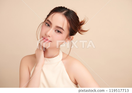 Beautiful young asian woman with clean fresh skin on beige background, Face care, Facial treatment, Cosmetology, beauty and spa, Asian women portrait. Beautiful young asian woman with clean fresh skin on beige background, Face care, Facial treatment, Cosmetology, beauty and spa, Asian women portrait. 119517713