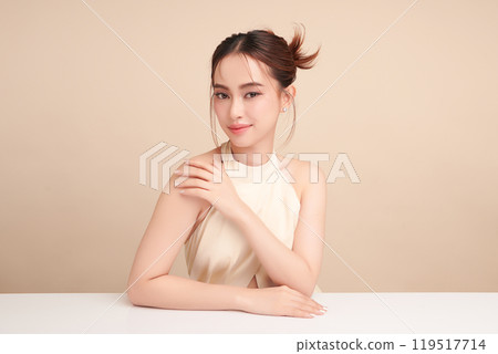 Beautiful young asian woman with clean fresh skin on beige background, Face care, Facial treatment, Cosmetology, beauty and spa, Asian women portrait. Beautiful young asian woman with clean fresh skin on beige background, Face care, Facial treatment, Cosmetology, beauty and spa, Asian women portrait. 119517714