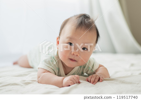 Baby lying on the windowsill Baby lying on the windowsill 119517740