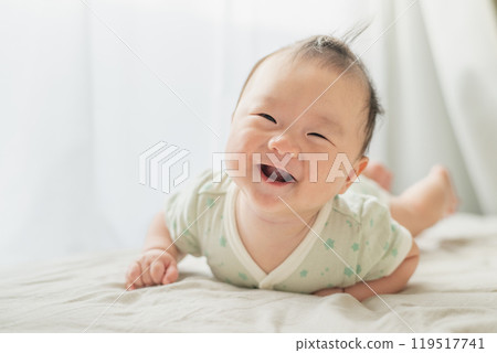Baby lying on the windowsill Baby lying on the windowsill 119517741