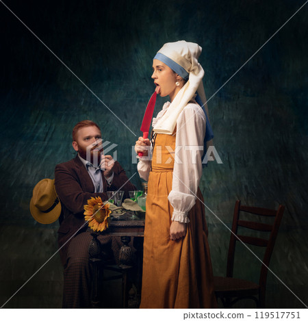 Woman in period attire playfully holding knife against vintage dark background. Spooky season. 119517751