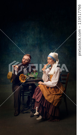 Cinematic portrait of man and woman sitting, drinking and eating pizza. Van Gogh and girl with white pearl at modern dinner. 119517766