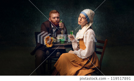 Couple drinking absinthe in vintage clothing. Bearded man in suit and elegant woman in period clothes sitting and drinking Couple drinking absinthe in vintage clothing. Bearded man in suit and elegant woman in period clothes sitting and drinking 119517891