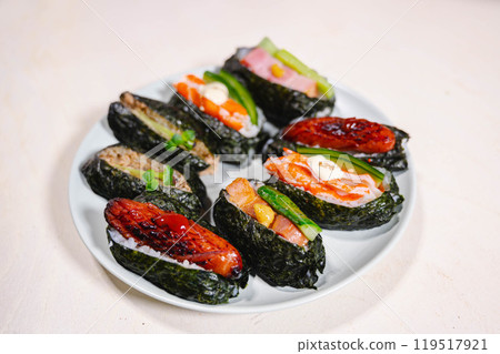 Long, thin rice balls stuffed with ingredients 119517921