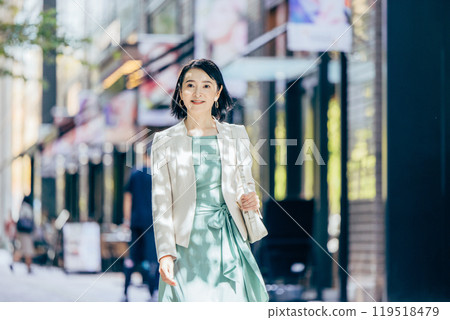 A woman in her 50s walking around town 119518479