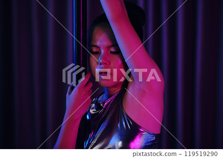 Reflective Asian Woman Standing by Vertical Pole 119519290