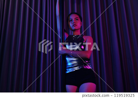 Striking Pose with Arm Raised in Neon Lighting 119519325