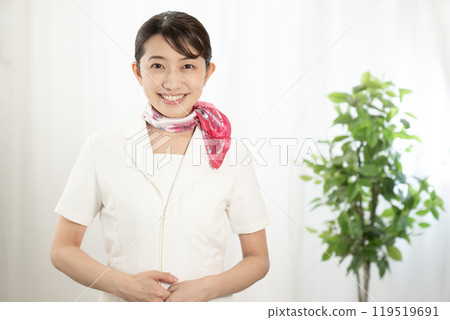 Aesthetician smiling with a scarf 119519691