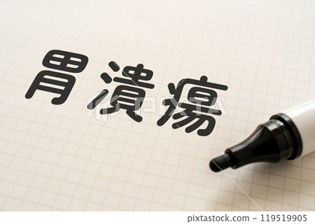 A notebook with the words stomach ulcer written on it and a marker 119519905