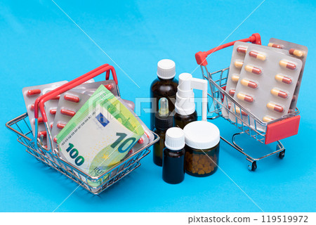 Pills and Capsules in Shopping Cart on Blue Background Pills and Capsules in Shopping Cart on Blue Background 119519972