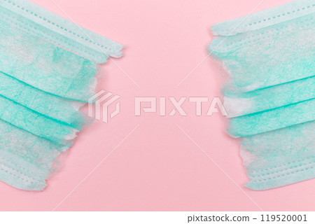 Green Torn Medical Face Mask on the Pink Background Green Torn Medical Face Mask on the Pink Background 119520001