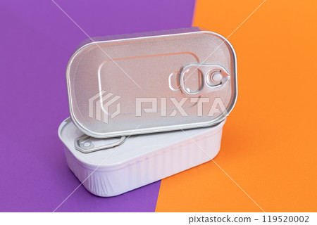 A Group of Stacked Tin Cans with Blank Edges on Split Orange and Violet Background A Group of Stacked Tin Cans with Blank Edges on Split Orange and Violet Background 119520002