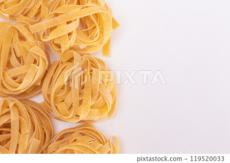 Classic Italian Raw Egg Fettuccine on White Background Classic Italian Raw Egg Fettuccine on White Background 119520033