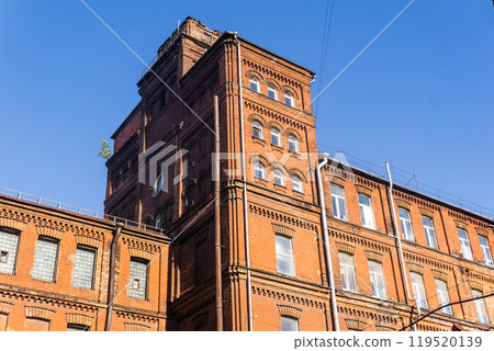 industrial architectural background, vintage factory building against a sky industrial architectural background, vintage factory building against a sky 119520139