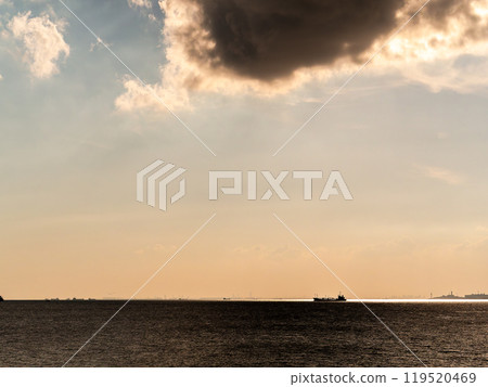 Evening view of Tokyo Bay: Offshore cargo ships, clouds and the sea Evening view of Tokyo Bay: Offshore cargo ships, clouds and the sea 119520469