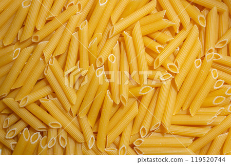 Uncooked Penne Rigate Pasta Background Uncooked Penne Rigate Pasta Background 119520744