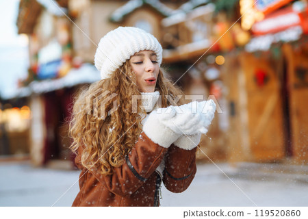 Beautiful woman walking between decorated stalls or kiosks in Christmas market. Travel concept. Beautiful woman walking between decorated stalls or kiosks in Christmas market. Travel concept. 119520860