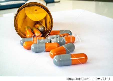 Medical capsules on a white table 119521121