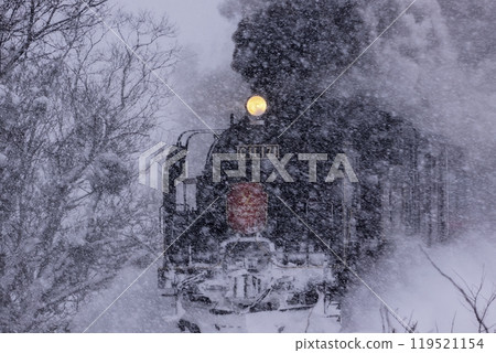 Steam locomotive running in the snow 119521154