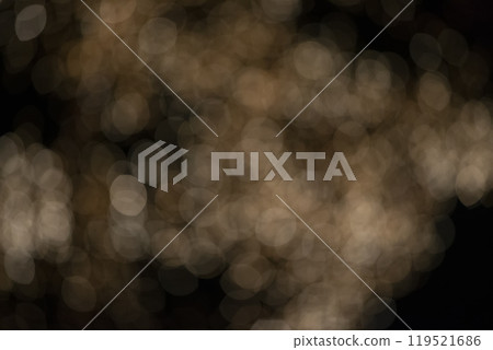 Golden blurred bokeh spots on a black background. Golden blurred bokeh spots on a black background. 119521686