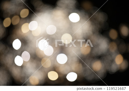 Golden large bokeh spots on a black background. Festive background. Golden large bokeh spots on a black background. Festive background. 119521687