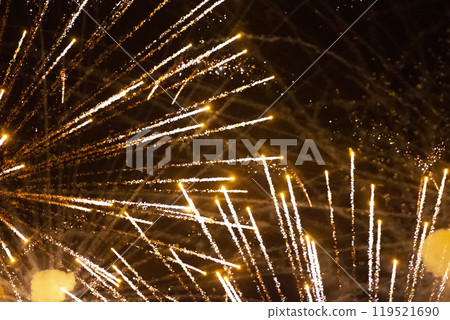Festive background golden rays of fireworks on a dark background. Festive background golden rays of fireworks on a dark background. 119521690
