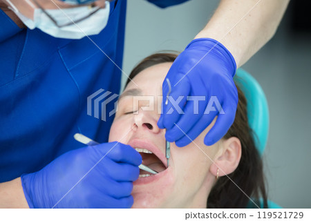 Dental treatment. Dental office. Doctor treats teeth. Woman in dentistry.Dental treatment. Dental office. Doctor treats teeth. Dental treatment. Dental office. Doctor treats teeth. Woman in dentistry.Dental treatment. Dental office. Doctor treats teeth. 119521729