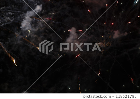 Smoke and spots of fireworks on a black background. Smoke and spots of fireworks on a black background. 119521783