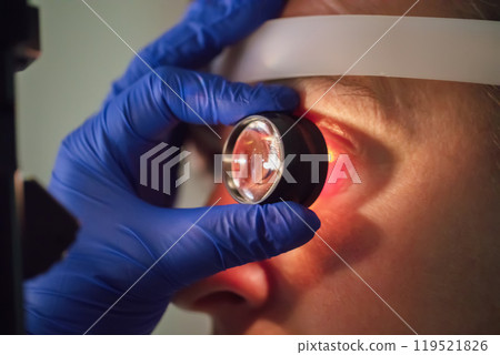 An ophthalmologist checks the fundus of the patient. An ophthalmologist checks the fundus of the patient. 119521826