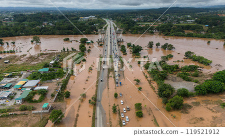Aerial view of car stuck on the bridge after road flooded during typhoon Yagi has swept Chiang Rai province of Thailand. 119521912