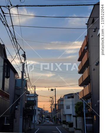 Evening view of downtown area with electric wires 119522044