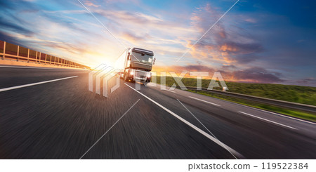 European truck driving on the asphalt road in rural landscape at sunset 119522384