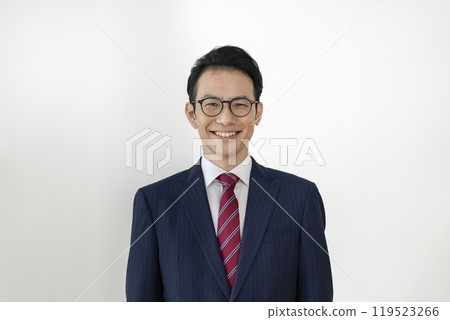A businessman in his late 30s smiling and looking at the camera 119523266