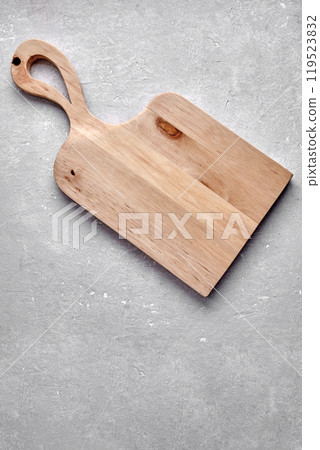 wooden cutting board of original shape on gray stone table wooden cutting board of original shape on gray stone table 119523832