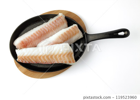 three pieces of raw cod fillet on a black cast iron frying pan prepared for frying isolated on white background three pieces of raw cod fillet on a black cast iron frying pan prepared for frying isolated on white background 119523960