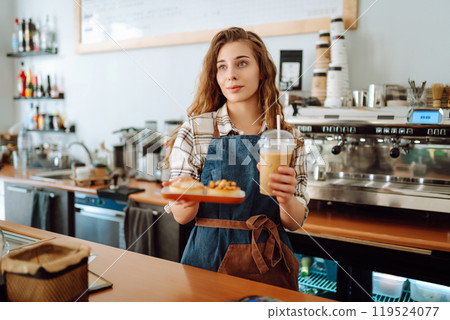 Woman barista holding takeaway coffee and dessert. Takeaway food and drink concept, small business. Woman barista holding takeaway coffee and dessert. Takeaway food and drink concept, small business. 119524077