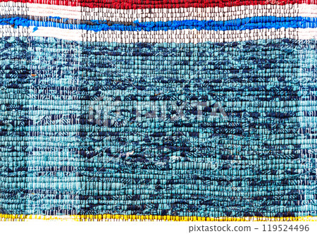 Old handmade homespun doormat from strips of cloth 119524496