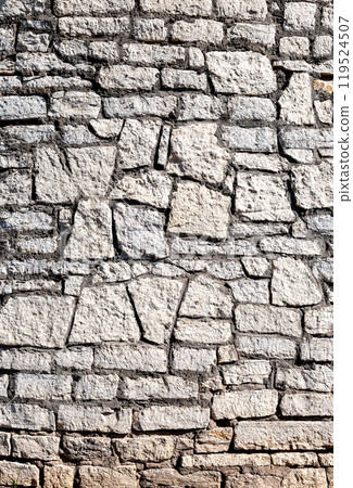 Ancient weathered rough stone wall as creative background Ancient weathered rough stone wall as creative background 119524507